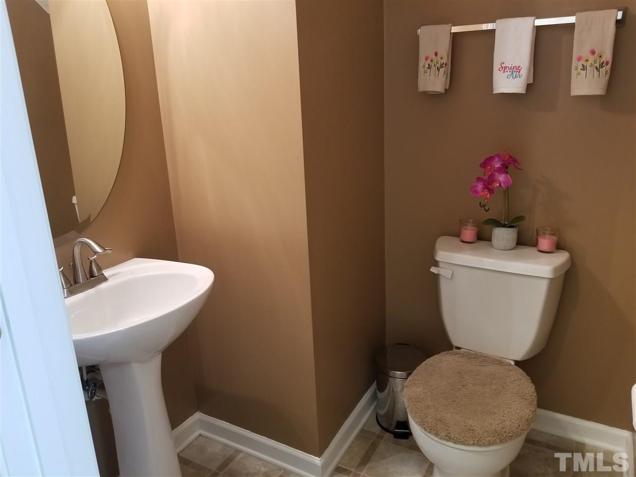 5832 Ricker Road Raleigh, NC 27610 - Photo 8 of 14 a white toilet sitting next to a white sink