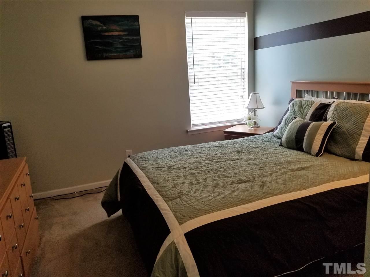 5832 Ricker Road Raleigh, NC 27610 - Photo 9 of 14 a bedroom with a bed and a window