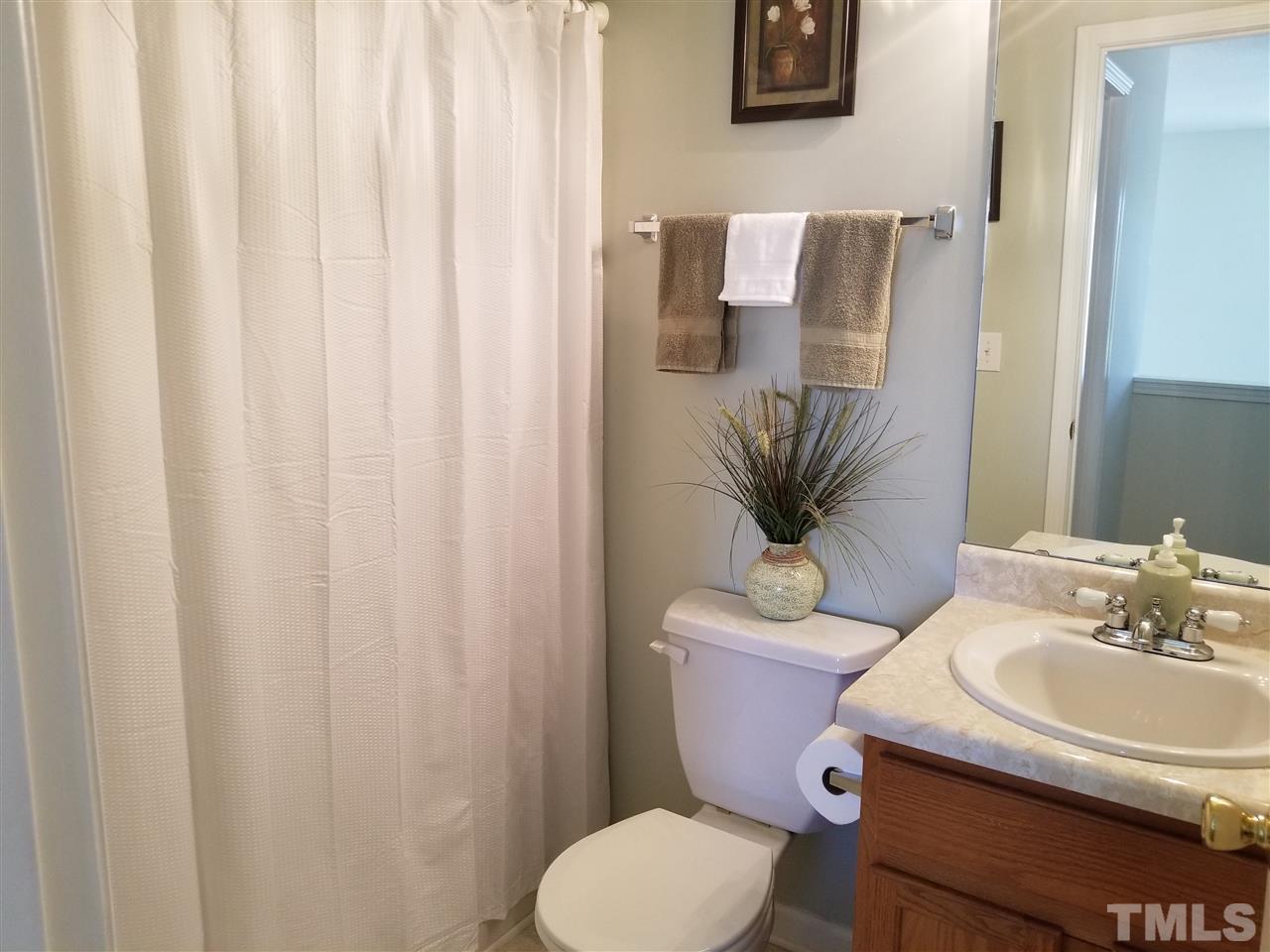 5832 Ricker Road Raleigh, NC 27610 - Photo 10 of 14 a bathroom with a toilet and sink