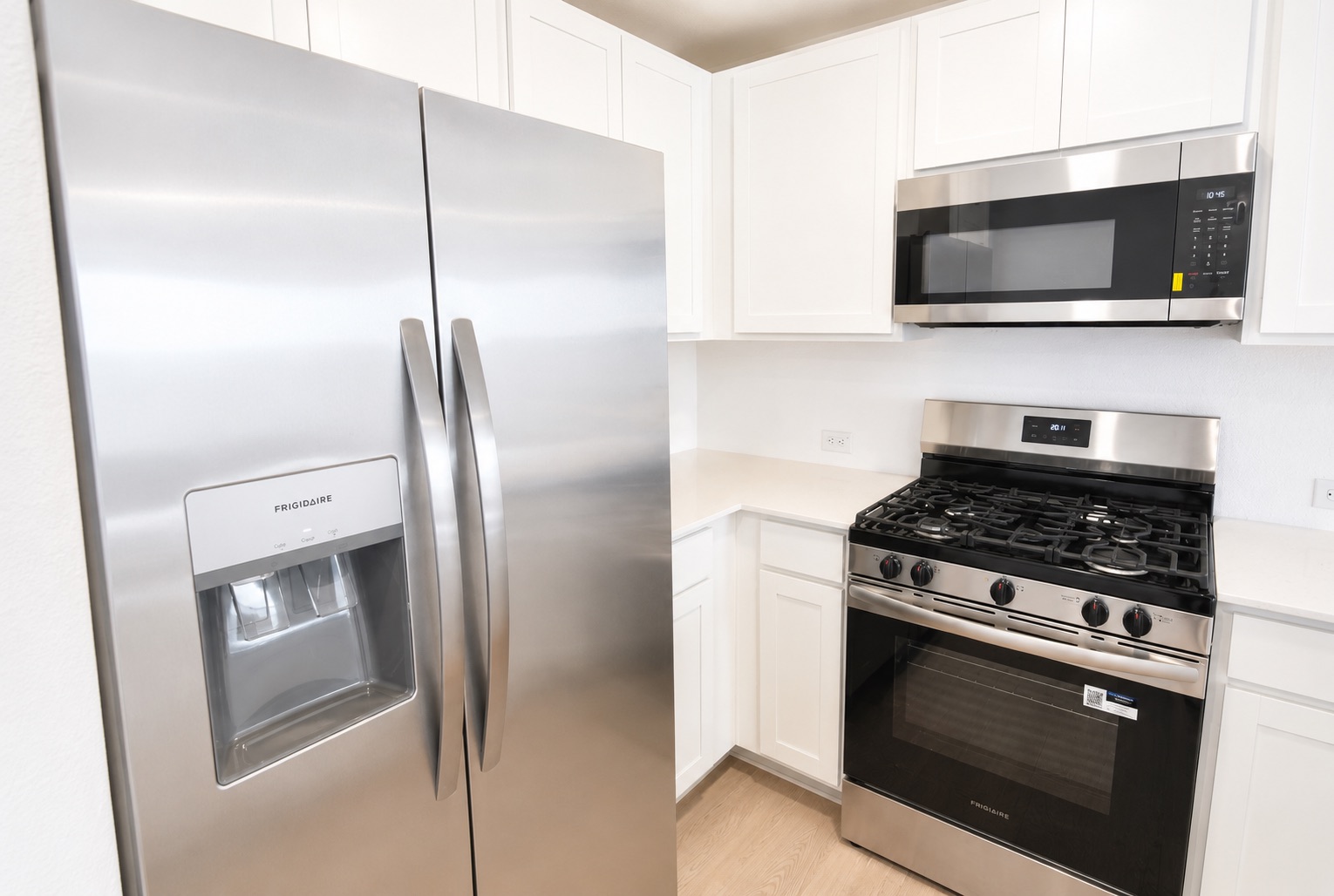 397 Keefer Kyle, TX 78640 - Photo 5 of 33 Stainless steel appliances and white cabinetry create a sleek, contemporary kitchen.