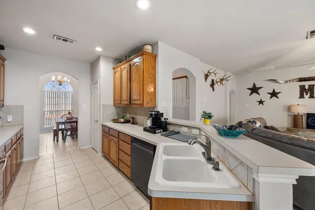a kitchen with a sink a stove and cabinets