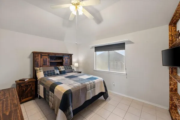 a bedroom with a bed and a tv