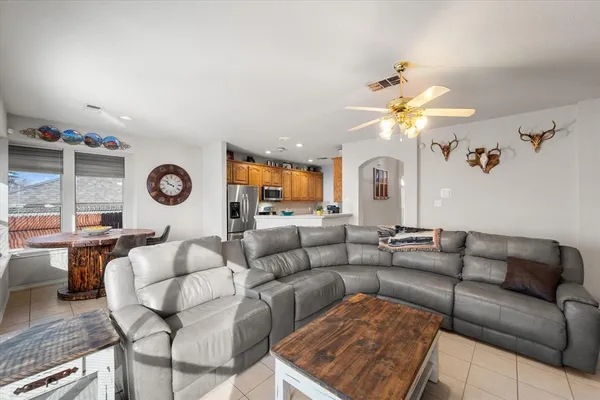 a living room with furniture and a chandelier