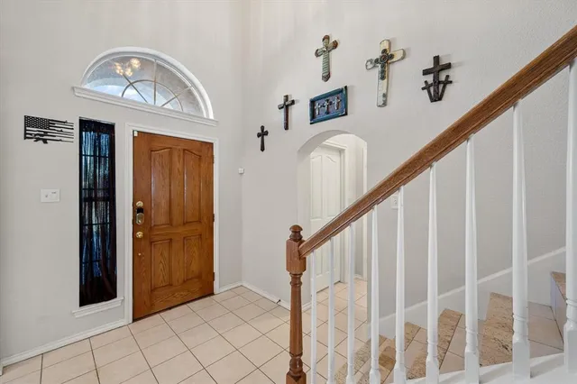 a view of a hallway with entryway wooden floor and front door