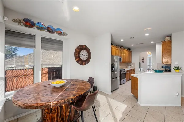 a view of a dining room and livingroom with furniture a kitchen view and a chandelier