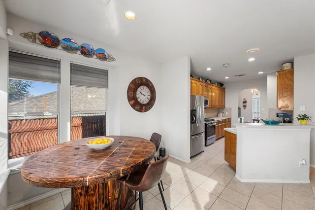 a view of a dining room and livingroom with furniture a kitchen view and a chandelier