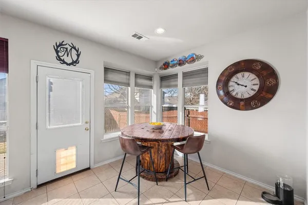 a view of a room that has a table and a chair in it