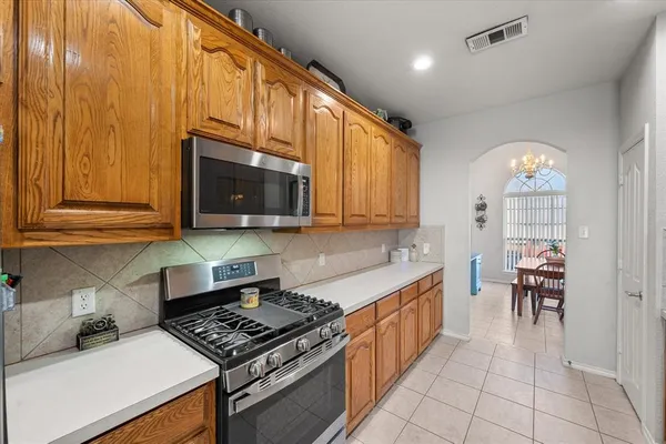 a kitchen with stainless steel appliances a stove a sink and a microwave