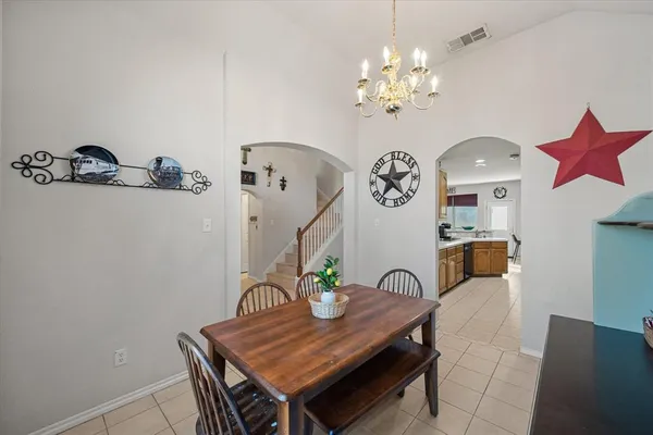 a view of a dining room with furniture and chandelier