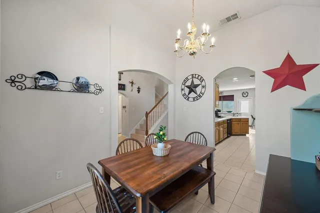 a view of a dining room with furniture and chandelier