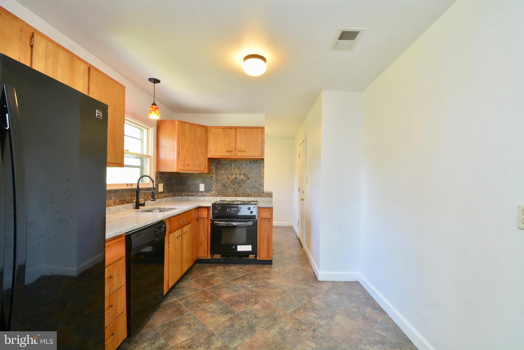 405 East Poplar Road Sterling, VA 20164 - Photo 11 of 30 Kitchen w/elegant black appliances - new stove too