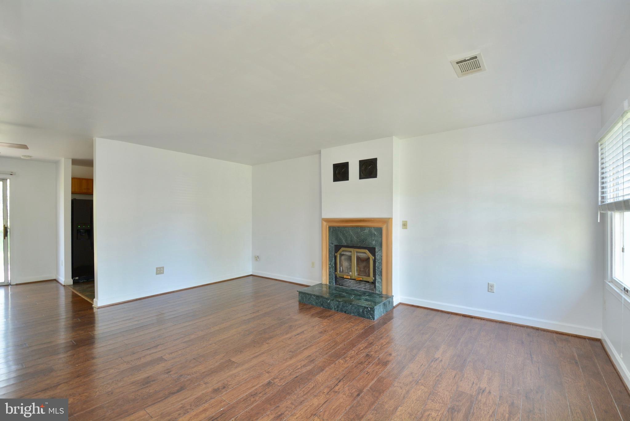 Living room w/hardwood laminate floors and firepla