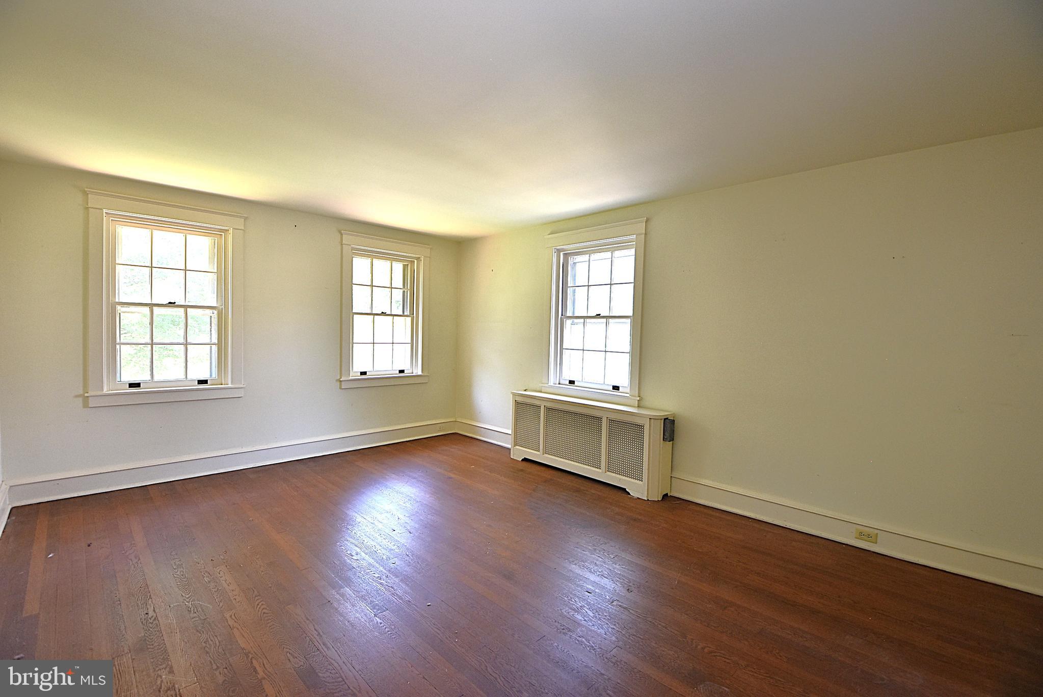 19 Farm Road Wayne, PA 19087 - Photo 15 of 41 an empty room with wooden floor and windows