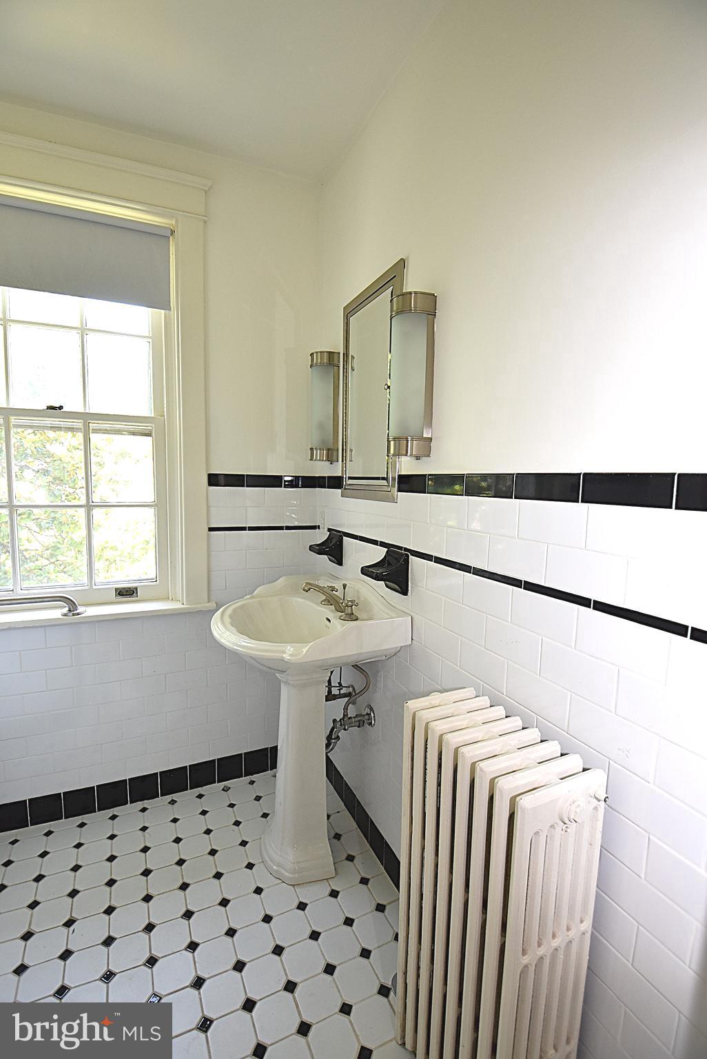 19 Farm Road Wayne, PA 19087 - Photo 17 of 41 a bathroom with a sink a mirror and a bathtub