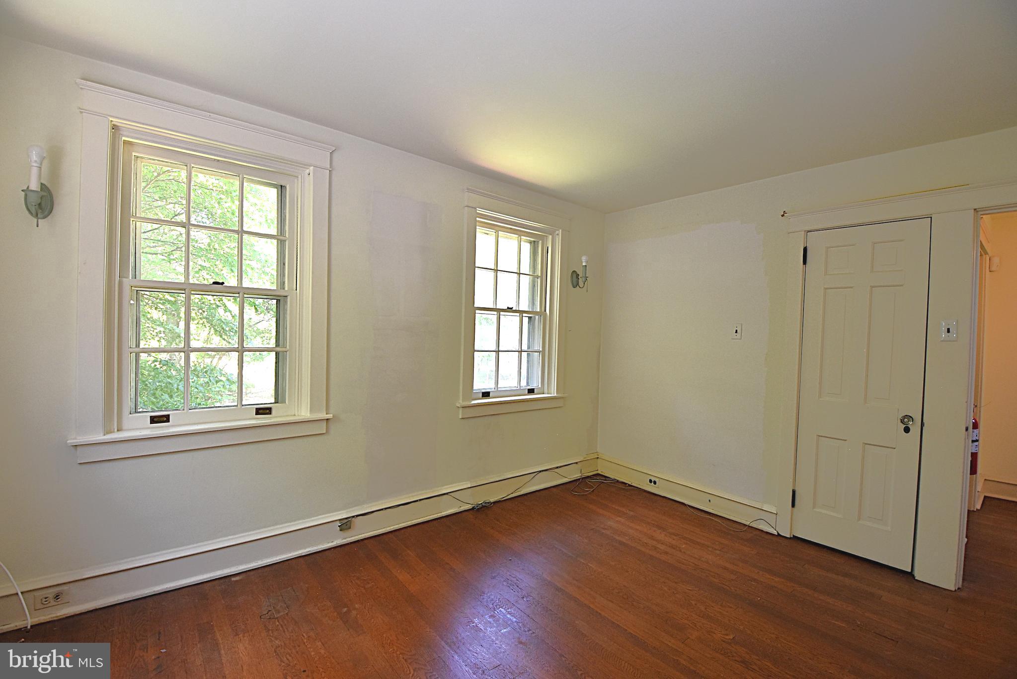 19 Farm Road Wayne, PA 19087 - Photo 19 of 41 an empty room with wooden floor and windows