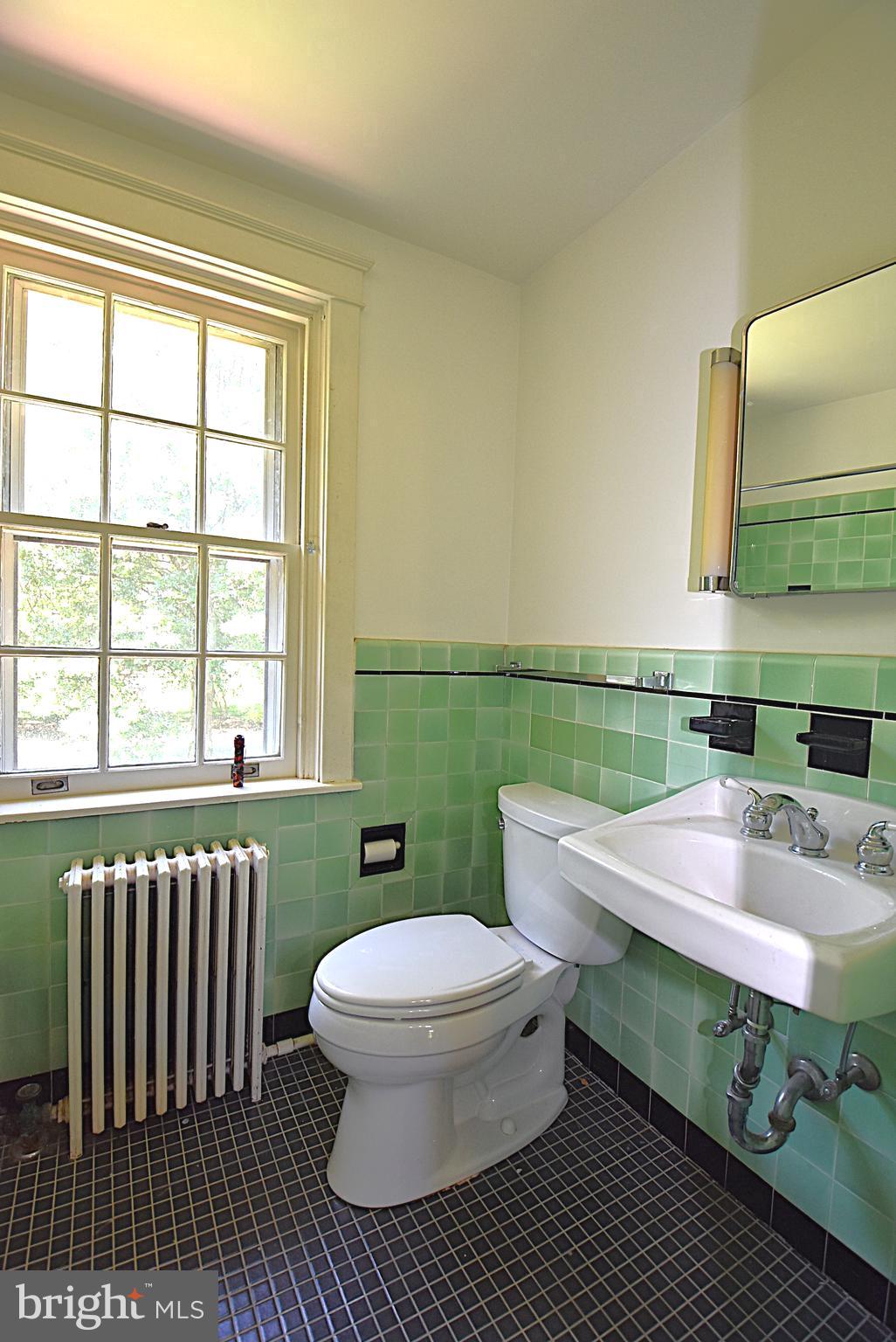 19 Farm Road Wayne, PA 19087 - Photo 23 of 41 a bathroom with a sink a toilet and a window