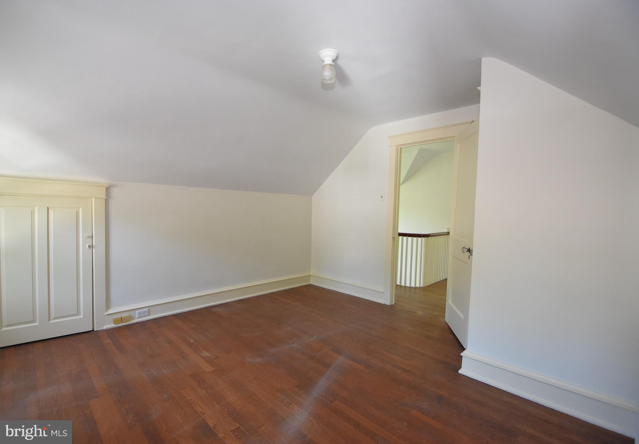 19 Farm Road Wayne, PA 19087 - Photo 27 of 41 an empty room with wooden floor and mirror