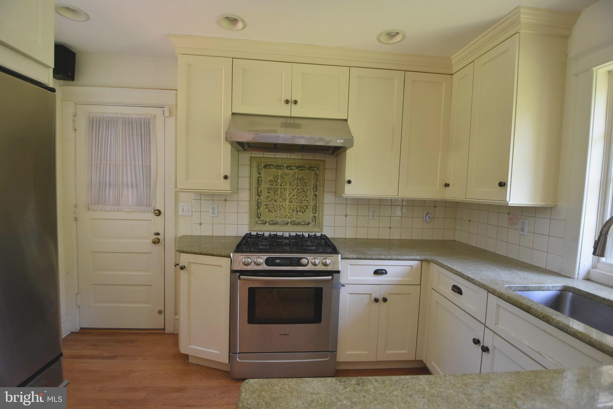 19 Farm Road Wayne, PA 19087 - Photo 4 of 41 a kitchen with granite countertop white cabinets and white stove