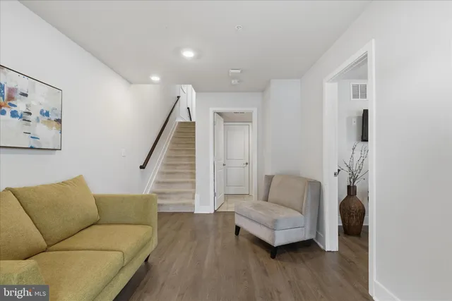 a living room with furniture and wooden floor