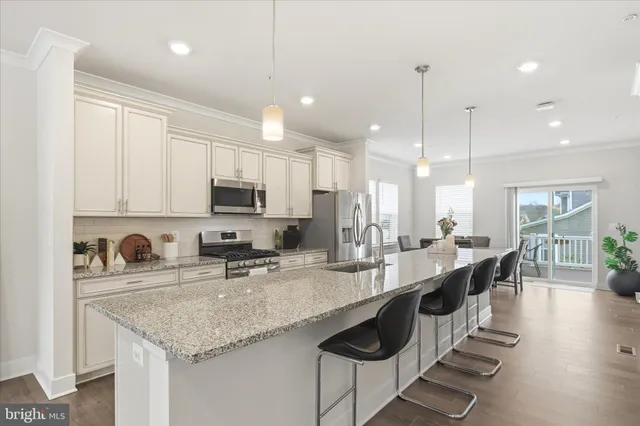 a kitchen with counter top space a sink appliances and cabinets