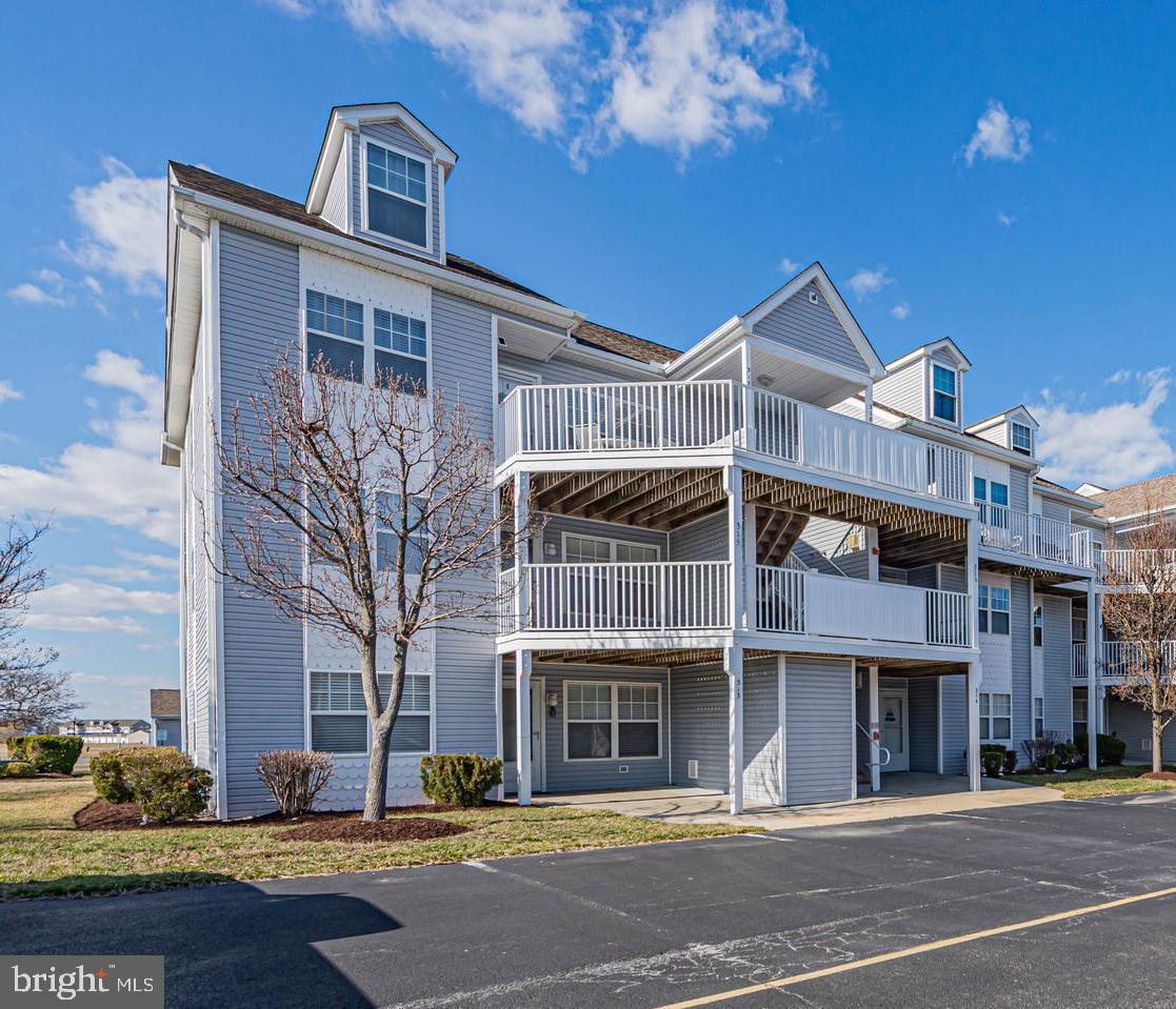 30381 Crowley Drive, Unit 313 Ocean View, DE 19970 - Photo 1 of 47 a front view of a building with street view