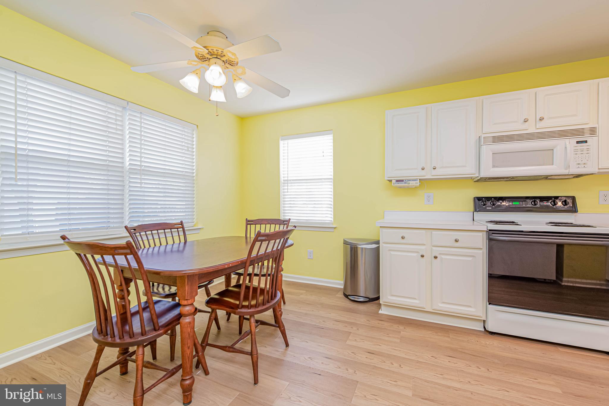 30381 Crowley Drive, Unit 313 Ocean View, DE 19970 - Photo 7 of 47 a kitchen with a table chairs and a stove