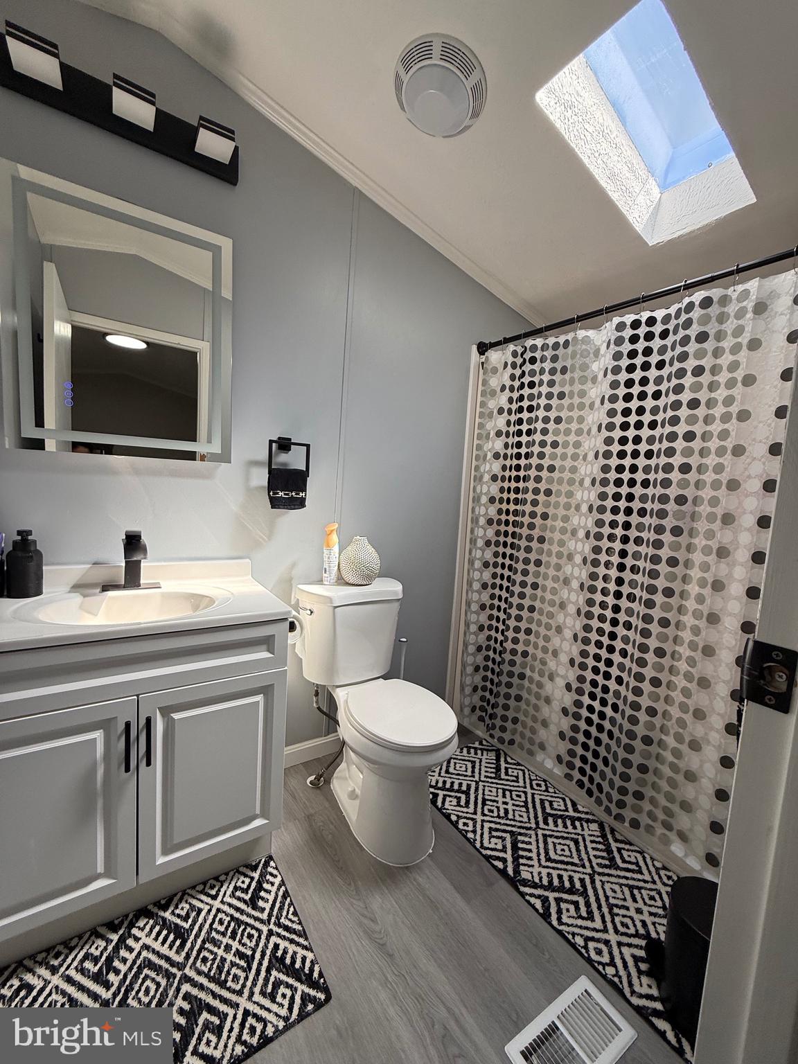 7959 Telegraph Road Severn, MD 21144 - Photo 16 of 18 a bathroom with a sink toilet and shower