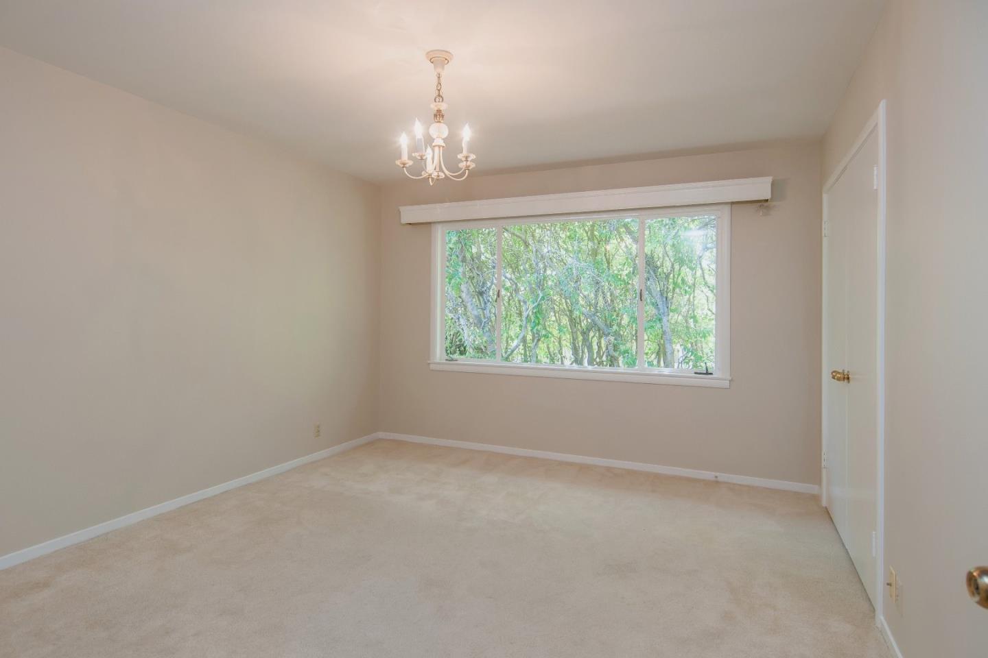 480 Darrell Road Hillsborough, CA 94010 - Photo 14 of 24 an empty room with windows and outdoor view
