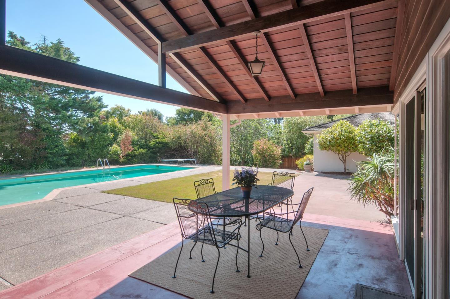 480 Darrell Road Hillsborough, CA 94010 - Photo 18 of 24 a view of a patio with a table chairs and a backyard