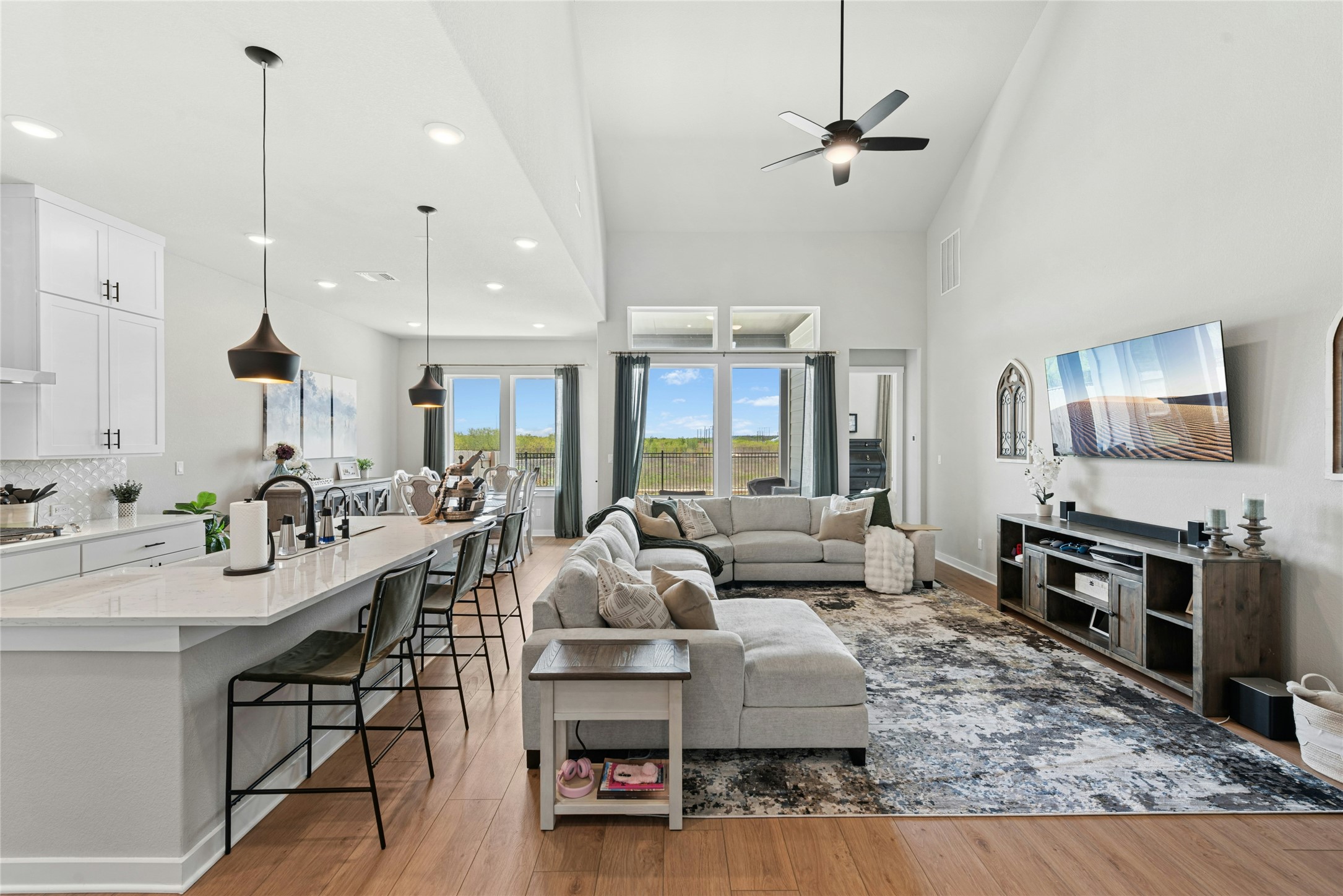 16213 Smithers Road Manor, TX 78653 - Photo 11 of 37 Open Living room with a lighted ceiling fan, plenty of natural light, a high ceiling, and recessed lighting