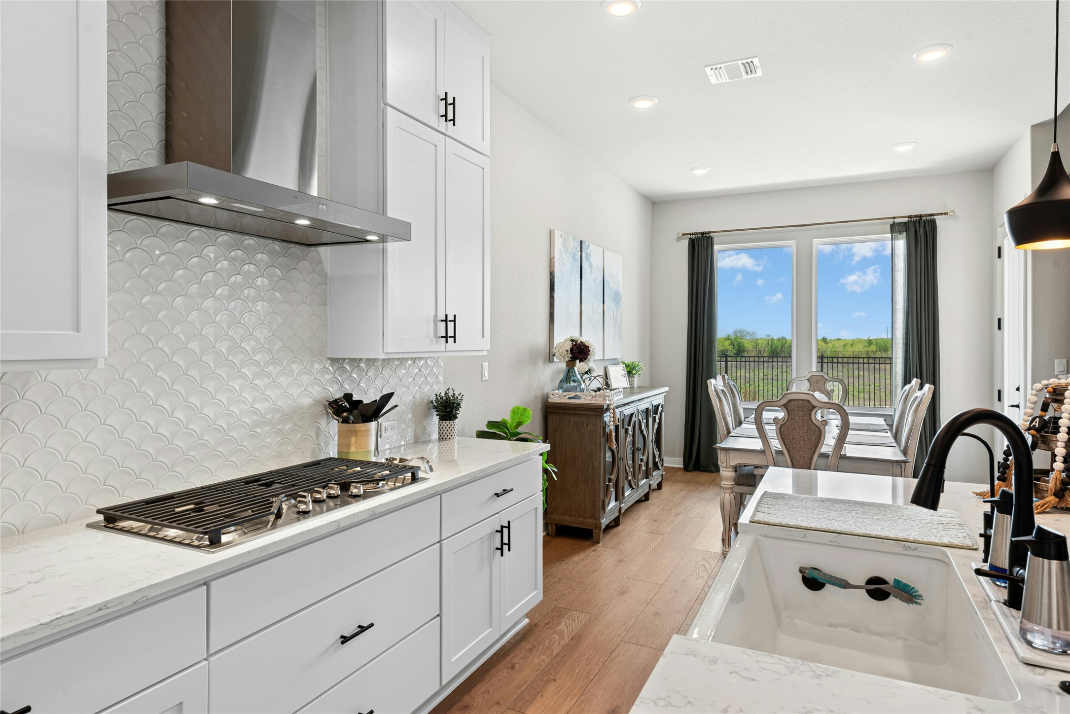 16213 Smithers Road Manor, TX 78653 - Photo 13 of 37 Kitchen with soft close white cabinets and light stone counters