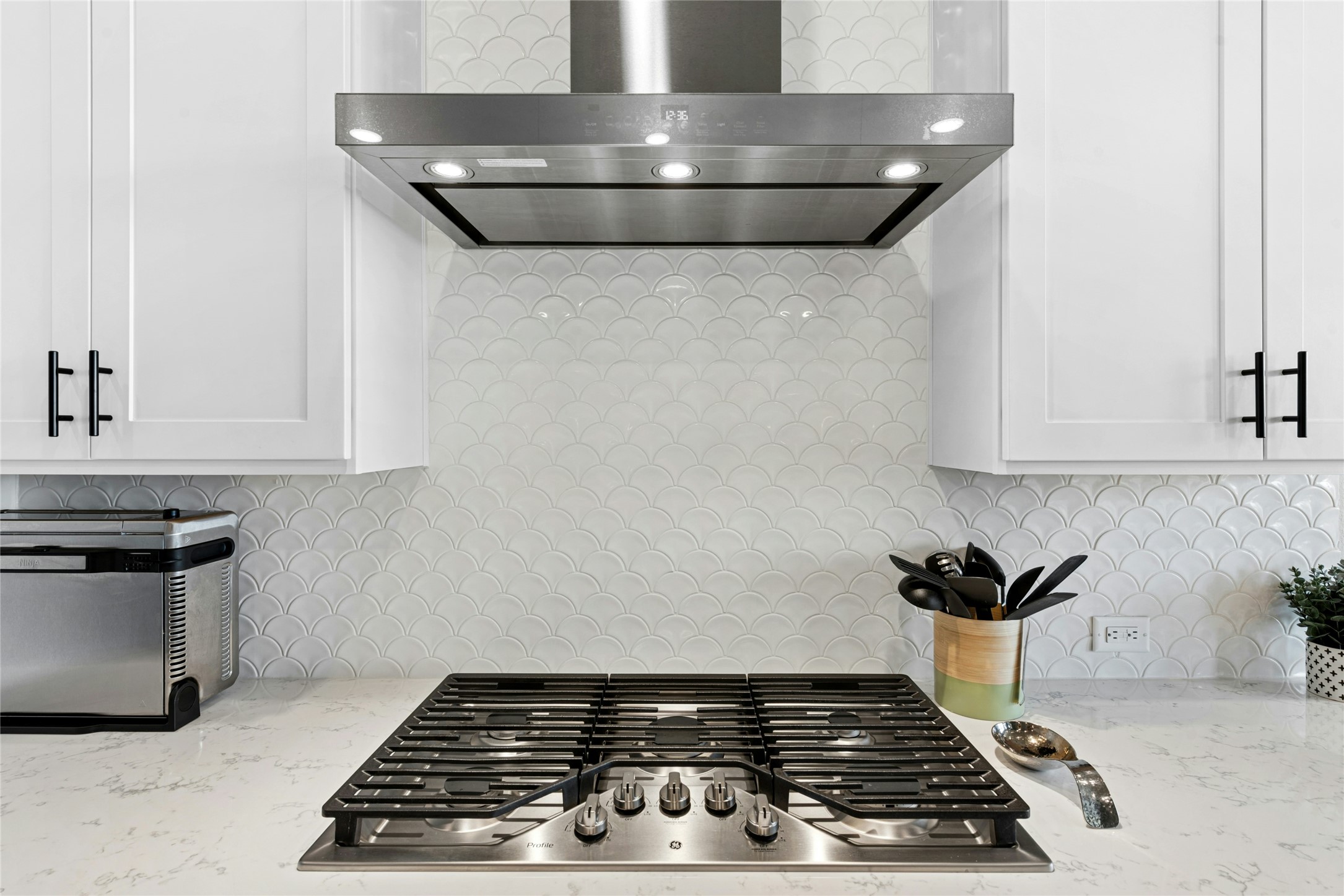 16213 Smithers Road Manor, TX 78653 - Photo 14 of 37 Kitchen view of 5 burner cooktop with modern exhaust system to ceiling
