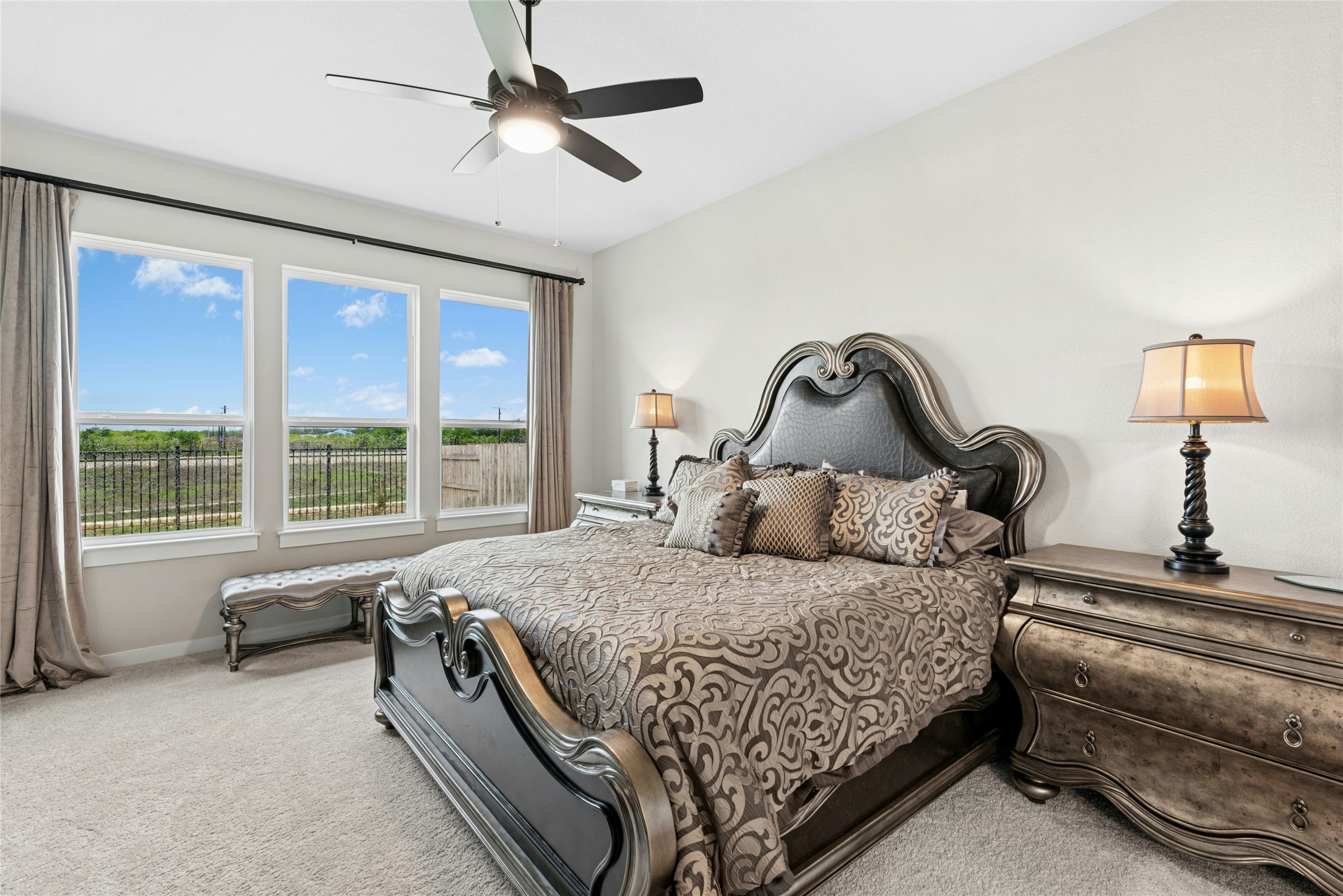 16213 Smithers Road Manor, TX 78653 - Photo 23 of 37 Bedroom with light carpet and a ceiling fan