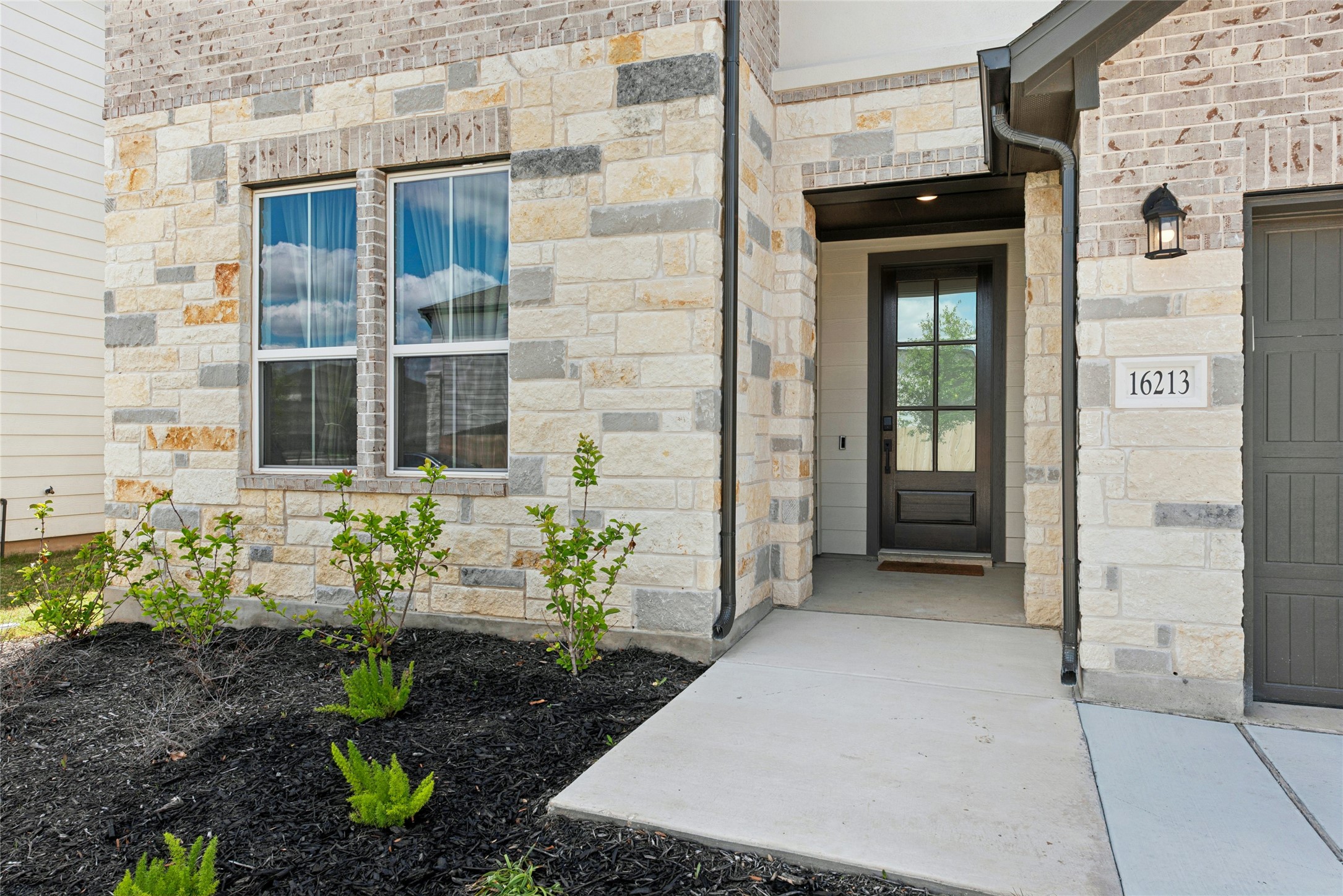 16213 Smithers Road Manor, TX 78653 - Photo 3 of 37 Property entrance with masonry front elevation
