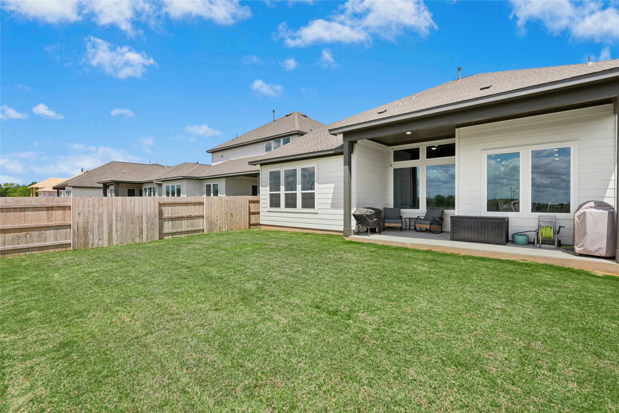16213 Smithers Road Manor, TX 78653 - Photo 37 of 37 Rear view of house with a patio area, a fenced backyard