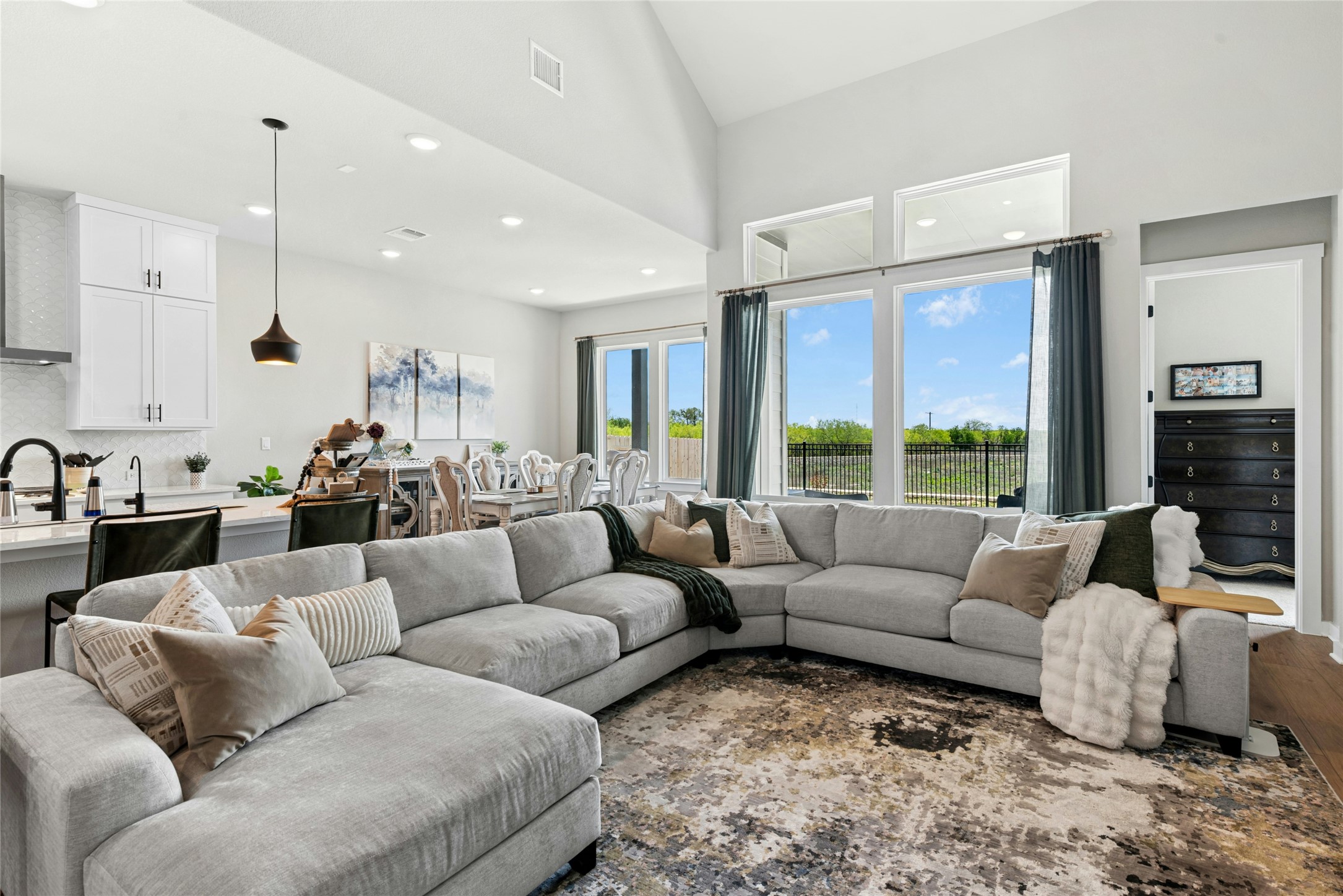 16213 Smithers Road Manor, TX 78653 - Photo 9 of 37 Open Living room with view of the backyard and high ceilings with recessed lighting.