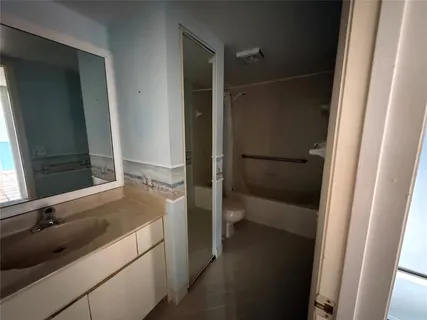 a bathroom with a tub and a sink