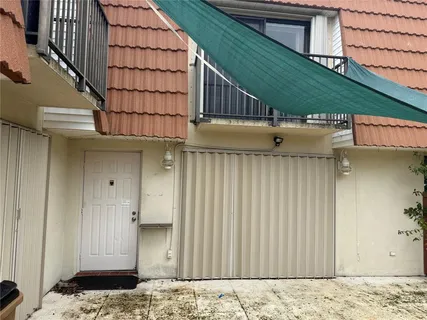 a view of a backyard with a wooden fence
