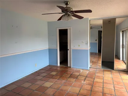 a bedroom with a bed and a chandelier fan