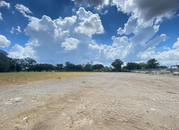 a view of a street with a yard