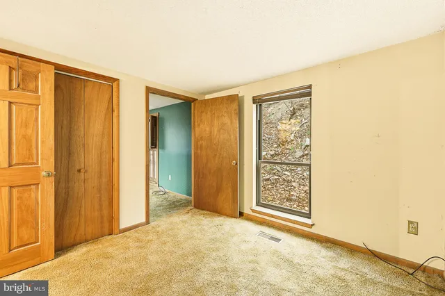 a view of a dining room with furniture and a chandelier
