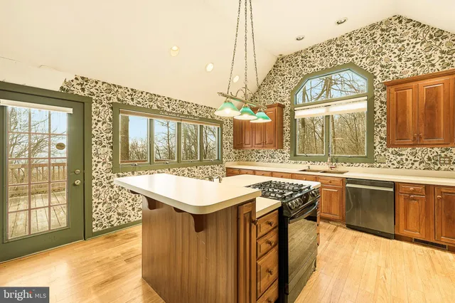 a kitchen that has a stove and a wooden floor