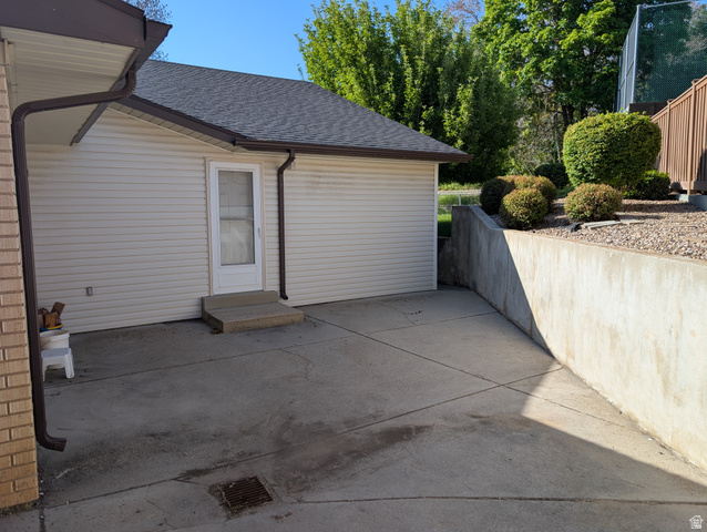 1411 Millbrook Way Bountiful, UT 84010 - Photo 5 of 36 Concrete patio area featuring a retaining wall