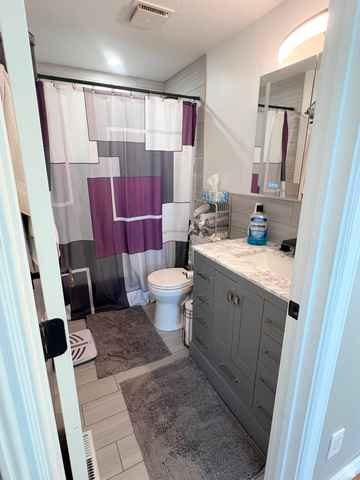 1852 East 3500th Street South Vernal, UT 84078 - Photo 20 of 46 Full bathroom with vanity, curtained shower, a textured ceiling, and light wood-style floors
