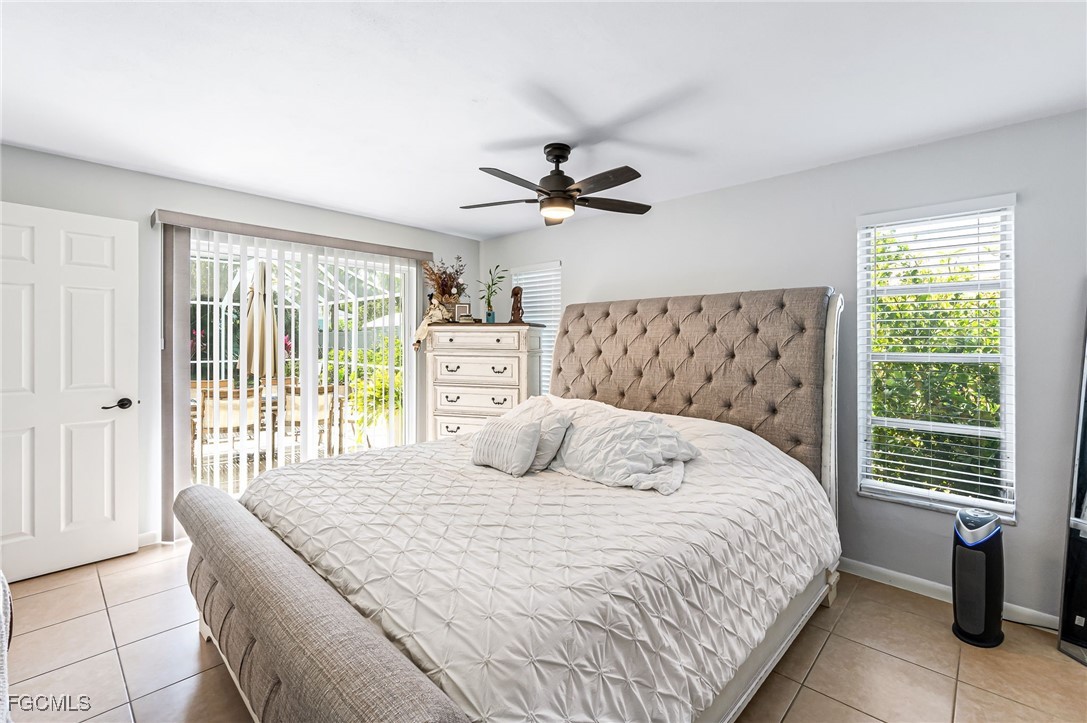 6519 East Town And River Road Fort Myers, FL 33919 - Photo 17 of 36 a bedroom with a large bed and a chandelier