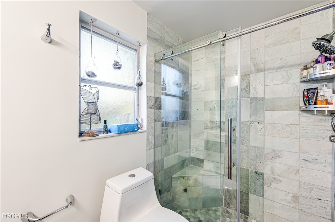 6519 East Town And River Road Fort Myers, FL 33919 - Photo 19 of 36 a bathroom with a shower and toilet