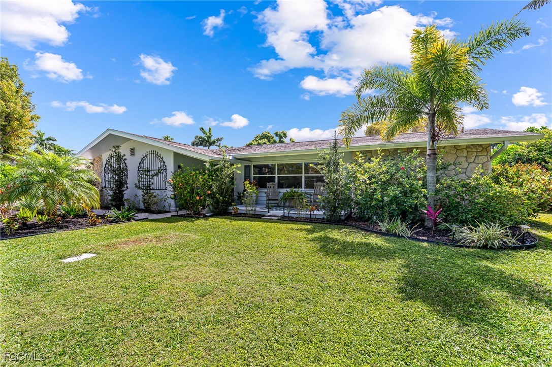 6519 East Town And River Road Fort Myers, FL 33919 - Photo 2 of 36 a view of a house with a yard and basketball court