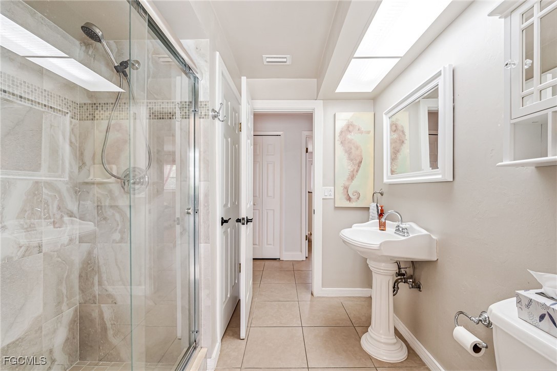 6519 East Town And River Road Fort Myers, FL 33919 - Photo 22 of 36 a bathroom with a sink a toilet and mirror