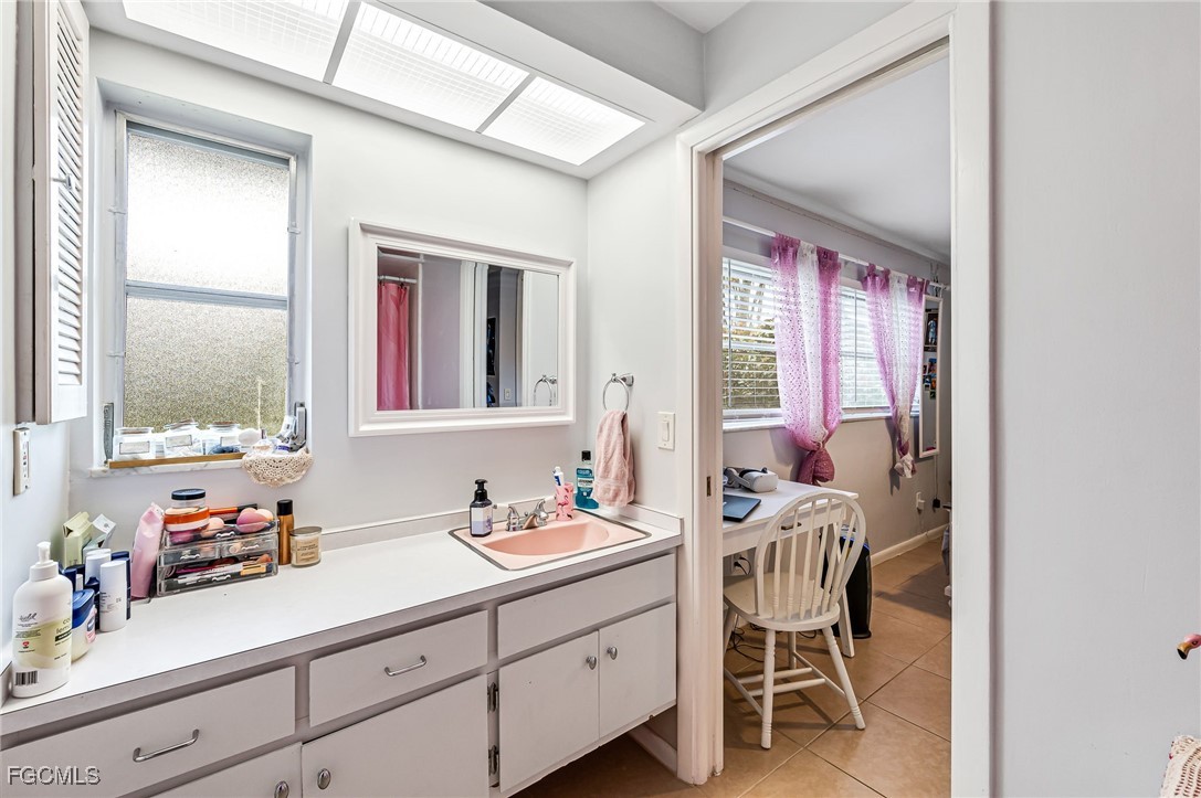 6519 East Town And River Road Fort Myers, FL 33919 - Photo 24 of 36 a bathroom with a sink mirror and a window