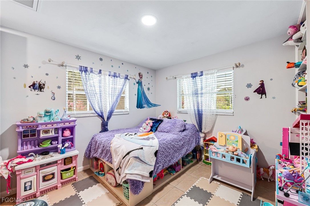 6519 East Town And River Road Fort Myers, FL 33919 - Photo 26 of 36 a bedroom with bed and a window
